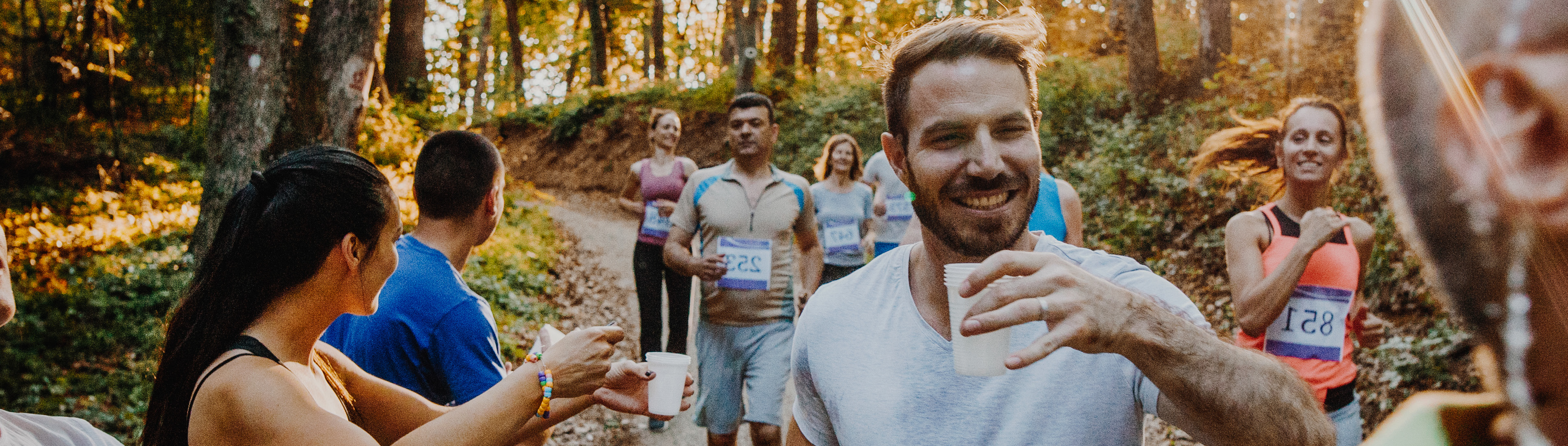 Läufer wird Wasser während des Marathons gereicht.